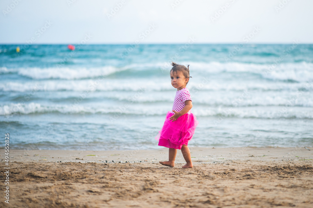 Portrait of cute little girl with pink dress on the beach. Portrait of cute little girl with pink dress on the beach.