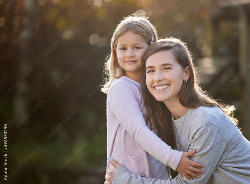 Fototapeta premium Shes my whole world. Cropped portrait of an attractive young woman and her daughter posing outside in the garden at home.