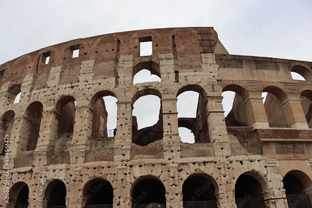 Obraz premium ROME, ITALY - February 05, 2022: Panoramic view of inside part of Colosseum in city of Rome, Italy. Cold and gray sky in the background. Macro photography of the arches.