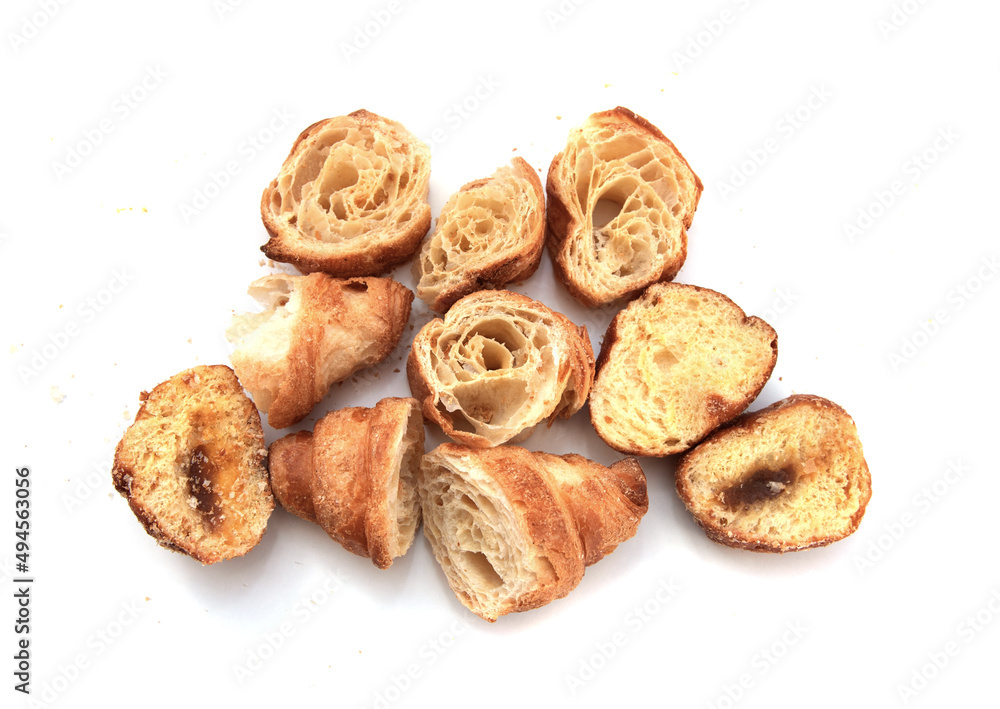 Pieces of dry croissant on a white background.