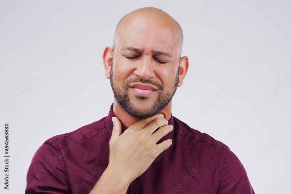 I think Ive lost my voice. Studio shot of a young man suffering with a sore throat against a grey background. I think Ive lost my voice. Studio shot of a young man suffering with a sore throat against a grey background.
