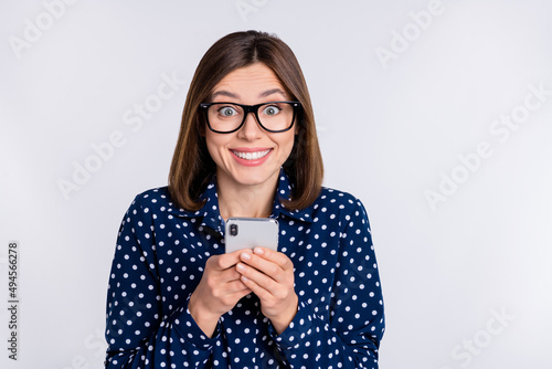 Bild auf Leinwand Photo of cheerful excited lady hold telephone enjoy feedback wear dotted blouse