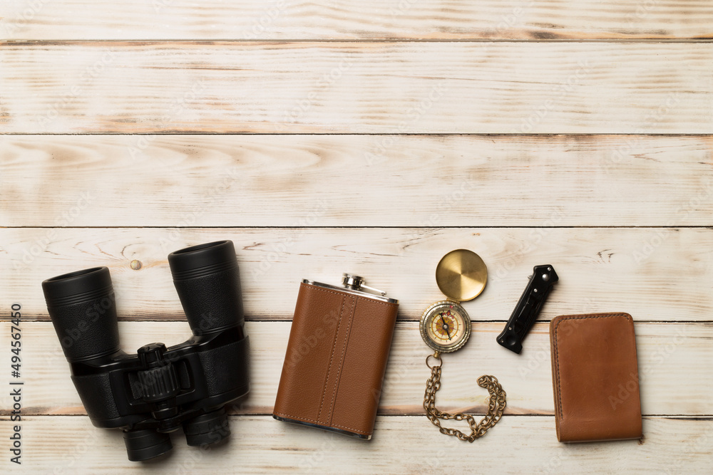 Travel accessories for mountain trip on wooden background, top view Travel accessories for mountain trip on wooden background, top view
