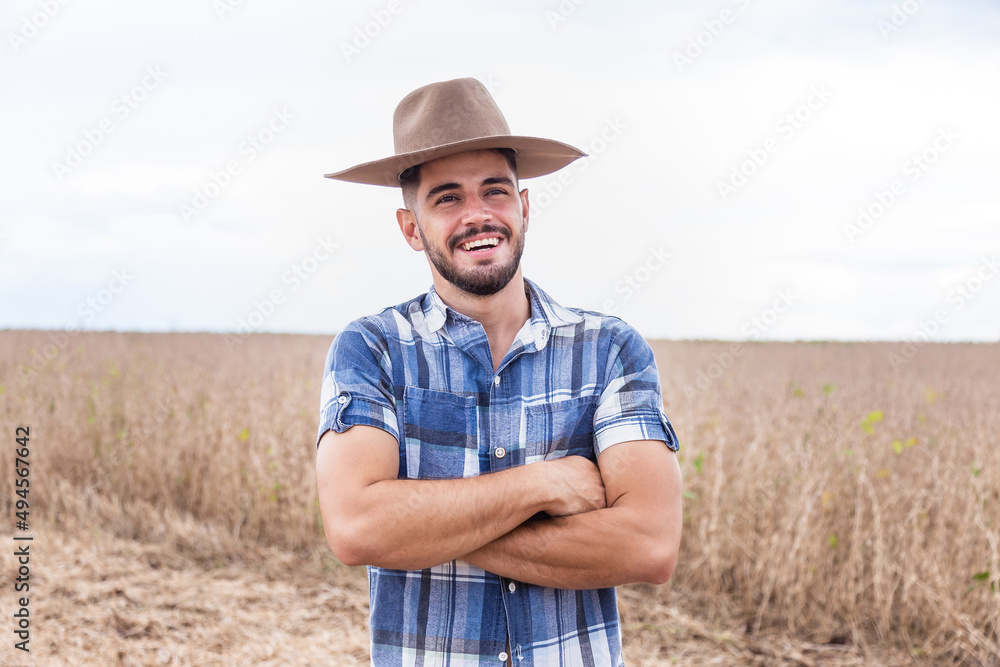 Portrait of a proud Latin American farmer standing with his arms crossed, looking at the camera. Portrait of a proud Latin American farmer standing with his arms crossed, looking at the camera.