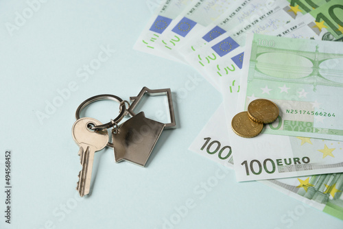Keys from a new house and euro currency paper banknotes and cents. Close up. Concept expensive utility bills and house payments. photo