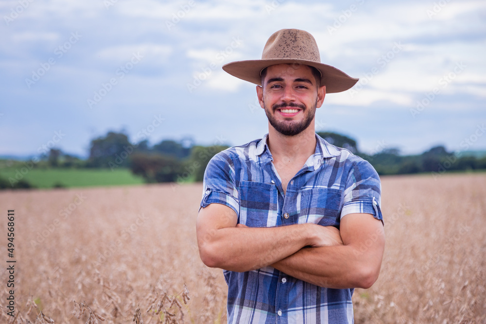 Portrait of a proud Latin American farmer standing with his arms crossed, looking at the camera.