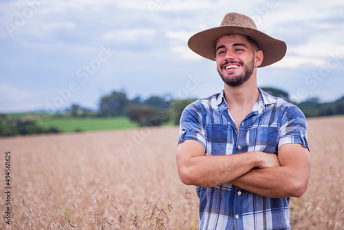 Portrait of a proud Latin American farmer standing with his arms crossed, looking at the camera.