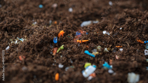 Microplastics inside the soil. Concept of global warming and climate change. Non-recyclable plastic pollution in the soil at the field.s