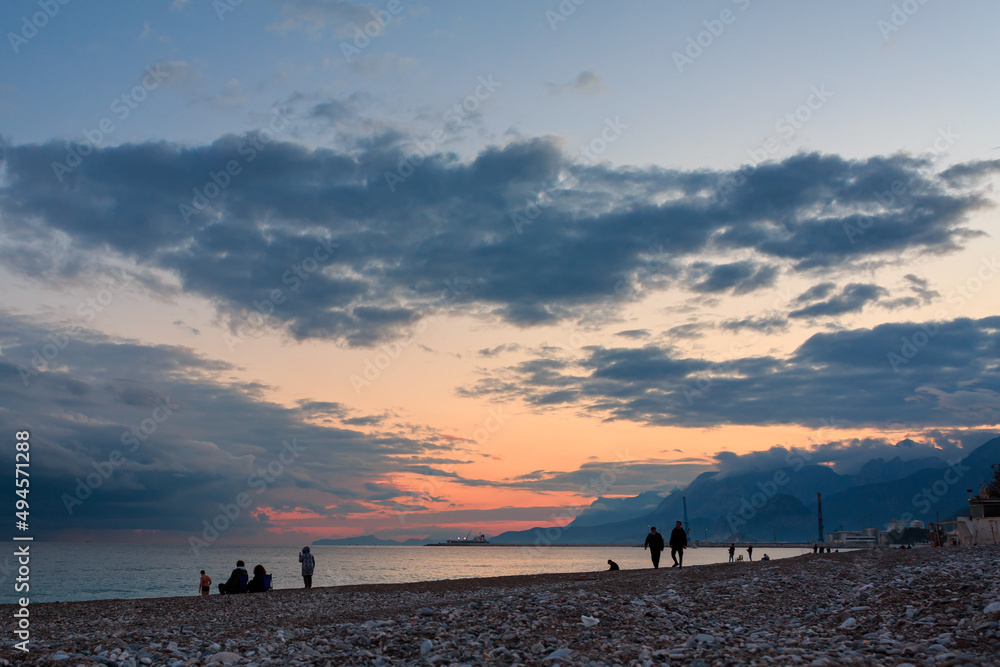 Pink sunset on the shores of the Mediterranean Sea, against the backdrop of mountains, rocky coast, summer, landscape, sea, mountains, sunset, colorful clouds, blue water. Pink sunset on the shores of the Mediterranean Sea, against the backdrop of mountains, rocky coast, summer, landscape, sea, mountains, sunset, colorful clouds, blue water.