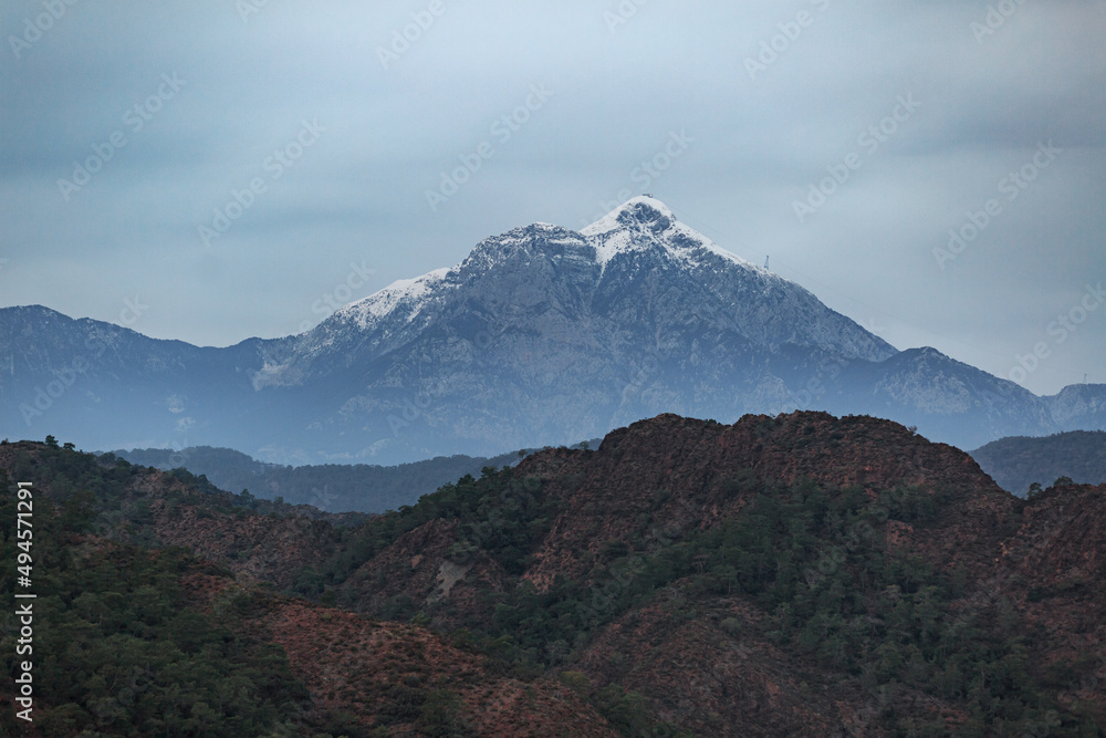 Fototapeta premium Mediterranean blue sea against the backdrop of snowy mountains