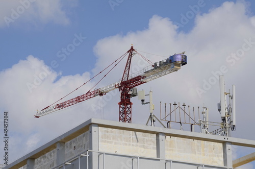 Construction crane. Construction of a high-rise building. The working process.