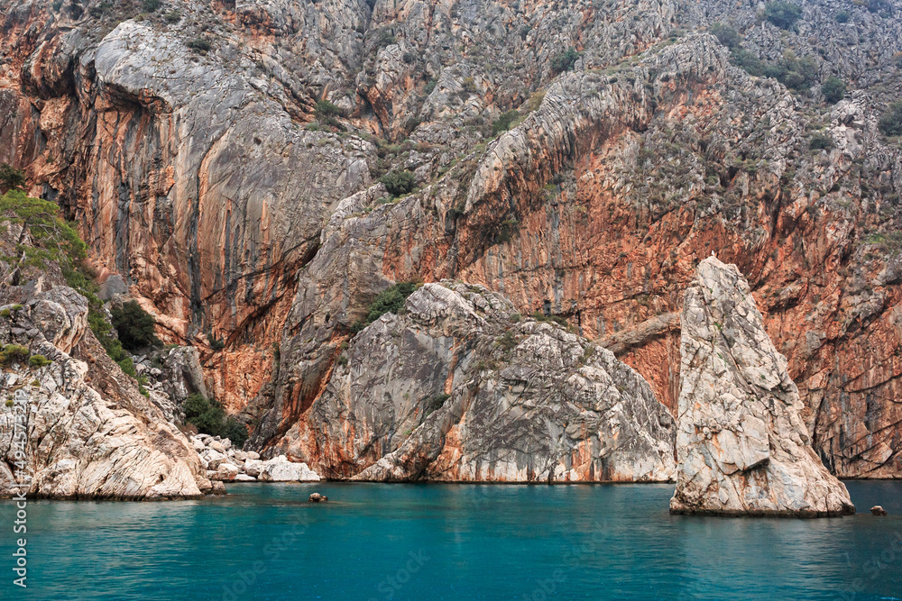 Texture rocks, blue sea, ship board, beautiful landscape, mountains, cracks, colorful mountains.