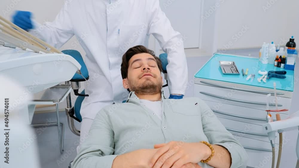 End of dental treatment. Happy patient smiles and shows thumbs up. Dentistry. End of dental treatment. Happy patient smiles and shows thumbs up. Dentistry.