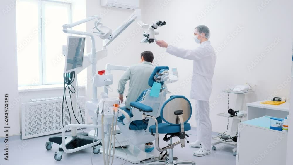 The patient sits down in the dental chair for dental treatment. Dentistry. Overall plan. The patient sits down in the dental chair for dental treatment. Dentistry. Overall plan.