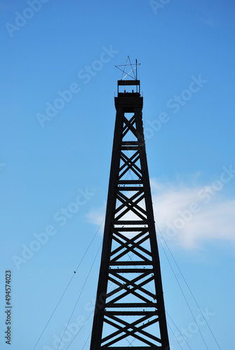 Wooden oil rig high in the sky outdoors.