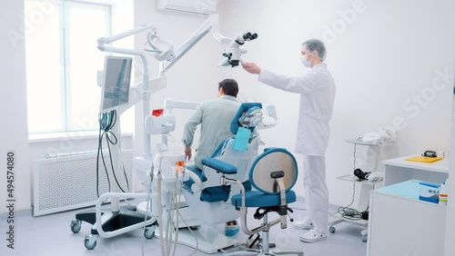 The patient sits down in the dental chair for dental treatment. Dentistry. Overall plan.