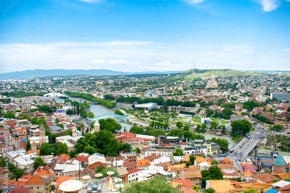 Aerial view panorama of old historic Tbilisi city center, mountains, architecture roofs buildings, river, Georgia in summer sunny day, scenic landscape