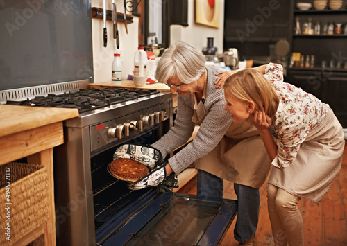 Getting baked. Shot of young woman learning baking tips from her grandmother.