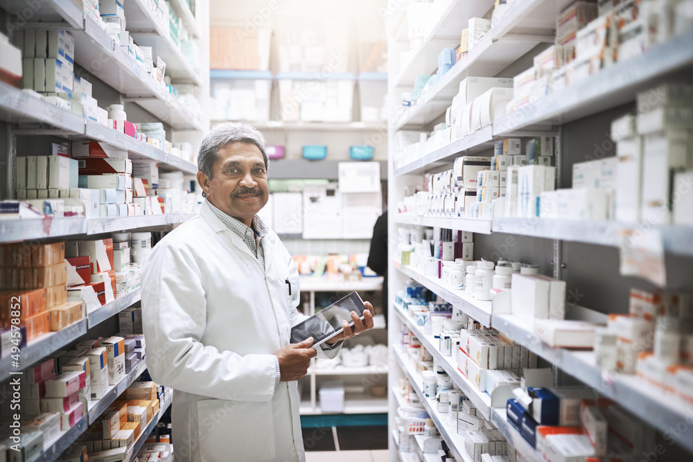 Making sure theres enough stock on the shelf. Cropped portrait of a handsome mature male pharmacist working in a pharmacy.