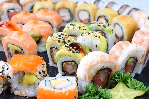 Traditional colorful suhi, cream cheese, salmon, caviar, rool sishi crunch, sesame seeds and sauce