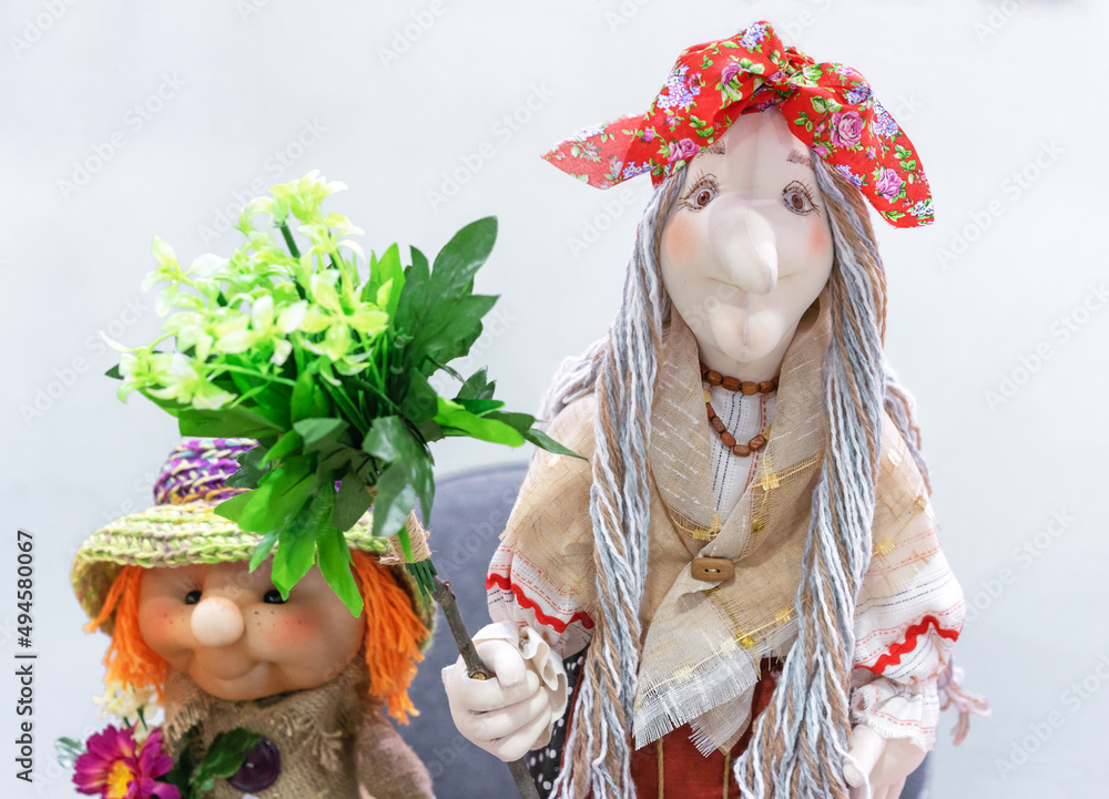 Witch soft toy with a flower. The character of Russian fairy tales is Baba Yaga.