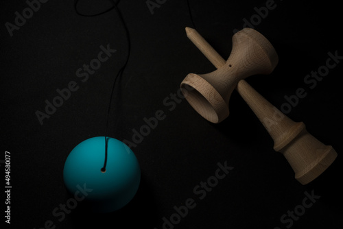 Kendama is a traditional Japanese skill toy. It consists of a handle (ken), a pair of cups (sarado), and a ball (tama) that are all connected together by a string photo