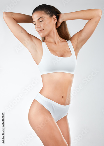 Believe in your inner beauty. Shot of a beautiful young woman posing in her underwear against a studio background.