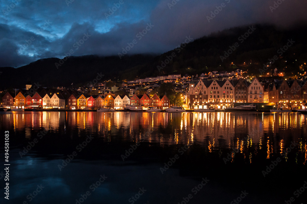 Evening view of illuminated wooden houses in the center of Bergen, Norway