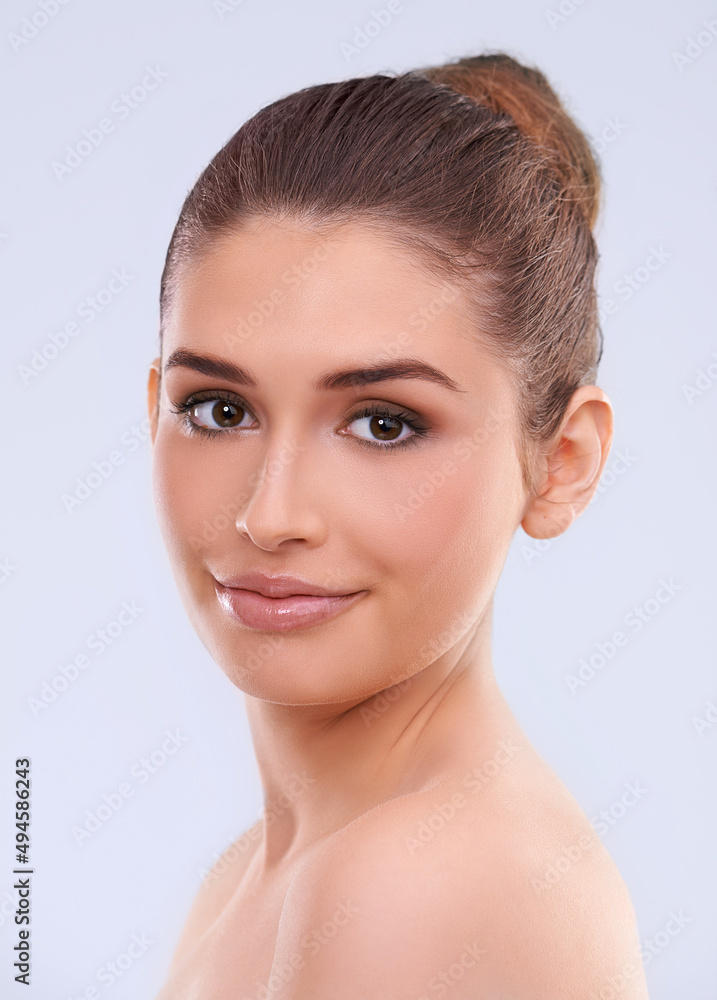 Im happy with my skin. Studio shot of a beautiful young woman with flawless skin looking over her shoulder. Im happy with my skin. Studio shot of a beautiful young woman with flawless skin looking over her shoulder.