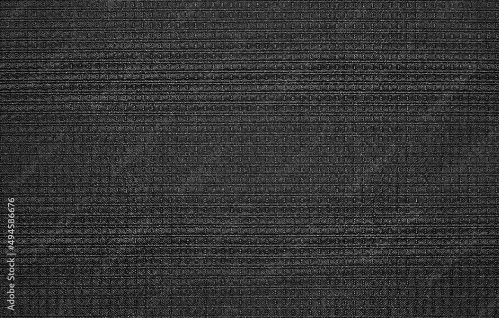The texture of nylon black fabric.Synthetic black nylon fabric. The background is nylon black. The texture of nylon black fabric.Synthetic black nylon fabric. The background is nylon black.