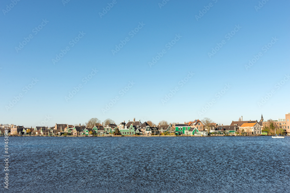 Shot of a Dutch village along the water on a clear sunny day
