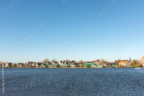 Shot of a Dutch village along the water on a clear sunny day