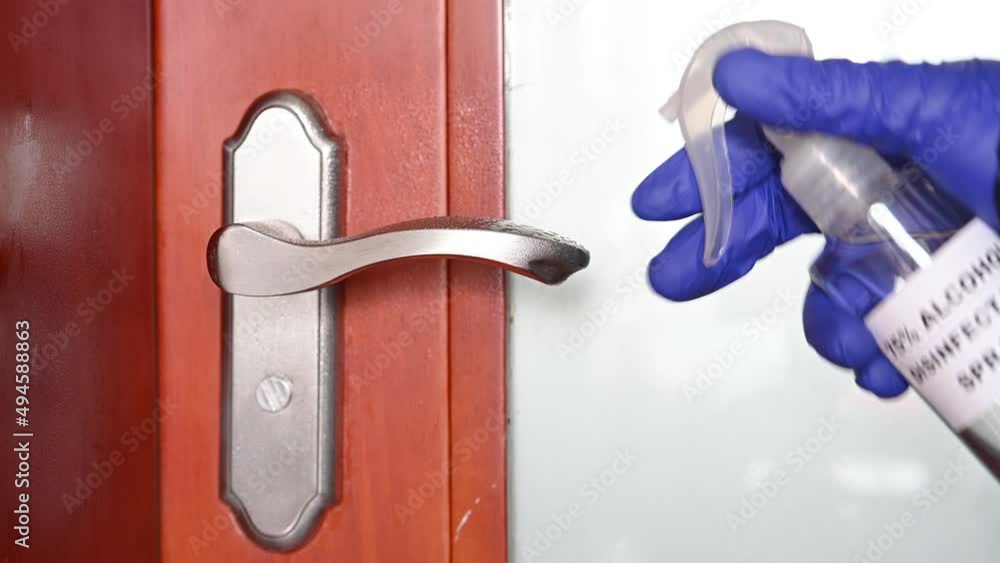 sprayed disinfectant alcohol to a door handle and then wiped it out