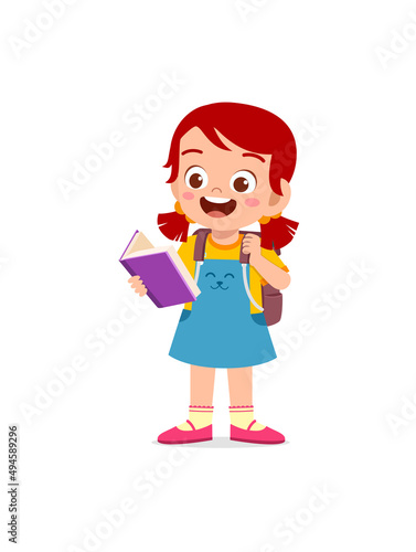 little kid standing and reading a story book