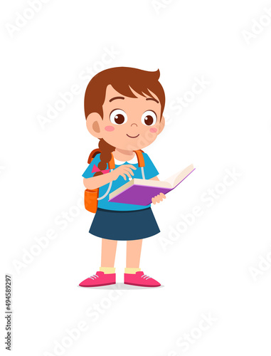 little kid standing and reading a story book