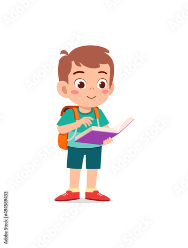 little kid standing and reading a story book