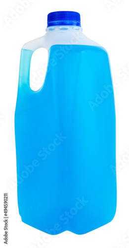 Plastic milk container with blue cap filled with blue liquid.