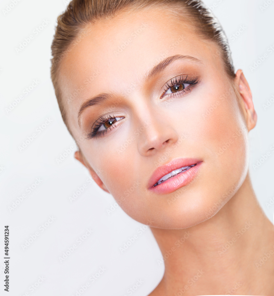 Unbelievably perfect A rare image of ultimate elegance.... Closeup of a naturally beautiful woman with flawless skin gazing at you, isolated on white.