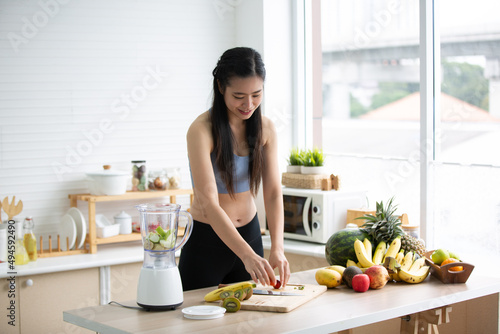 young Asian woman person cooking in kitchen with a healthy food concept  drink and organic vegetable
