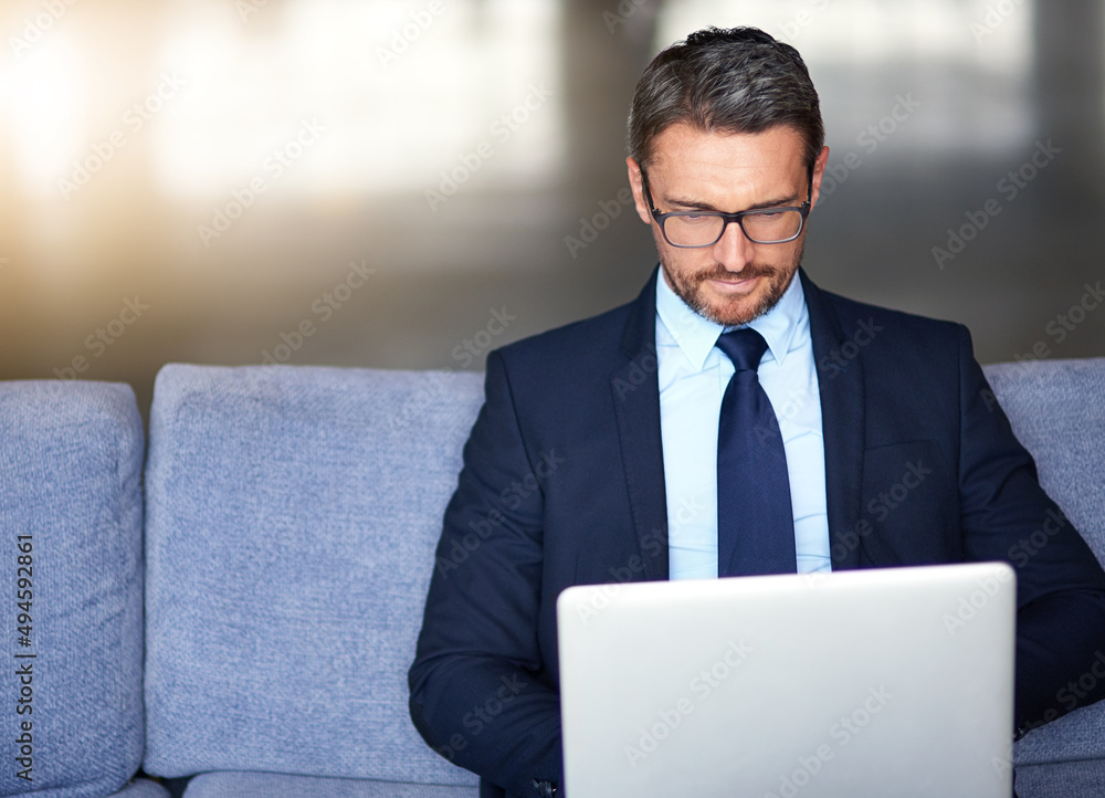Wireless technology brings business opportunities closer to him. Shot of a businessman using a laptop on the sofa. Wireless technology brings business opportunities closer to him. Shot of a businessman using a laptop on the sofa.