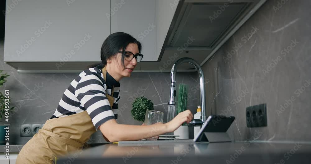 Young caucasian attractive woman using digital tablet on kitchen at home, routine. Young caucasian attractive woman using digital tablet on kitchen at home, routine.