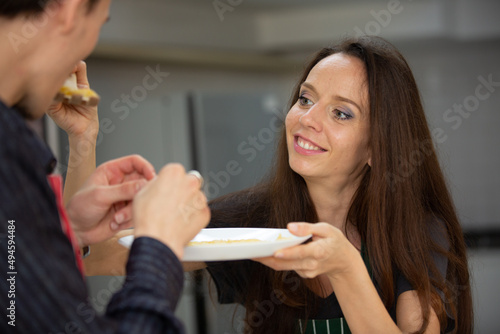 young couple person having fun and happy to cook a healthy food meal in home kitchen