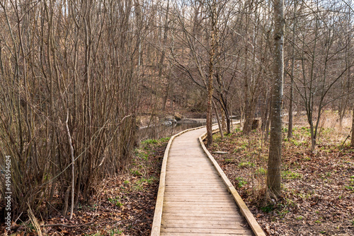 A wooden walkway through Frick Park in Pittsburgh, Pennsylvania, USA on a sunny spring day