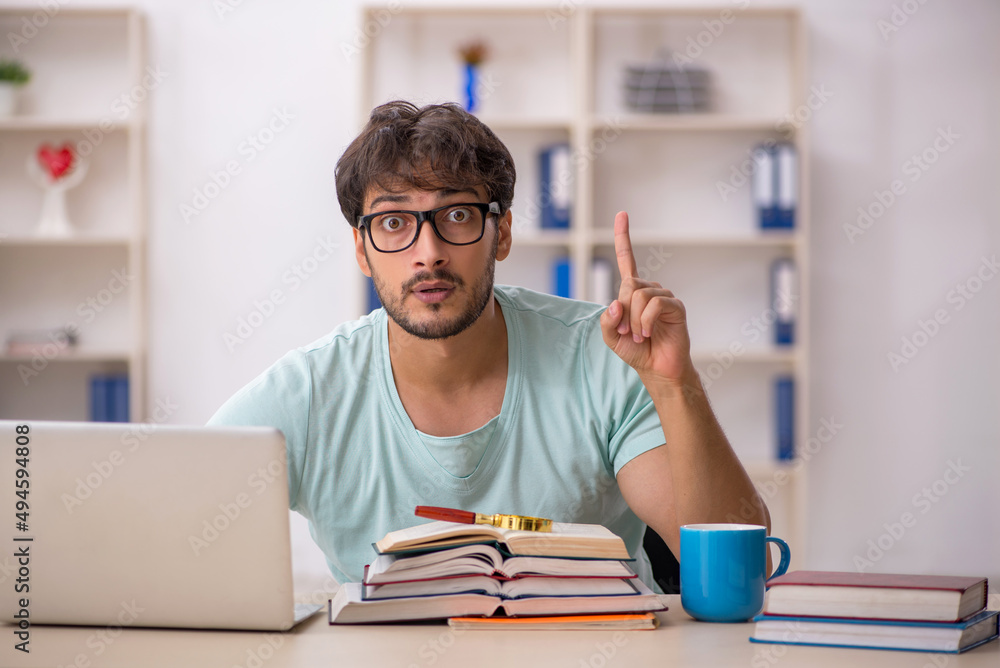 Young male student preparing for exams in the classroom Young male student preparing for exams in the classroom