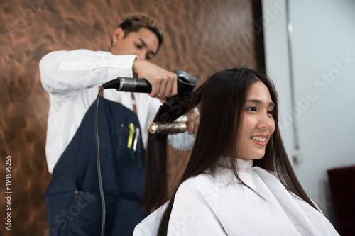 woman client person having a process to making treatment a hair with hairdresser in beauty salon