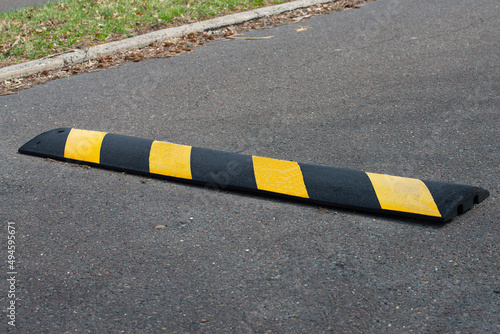 Canvas Print Black and yellow bright speed bumps on the road