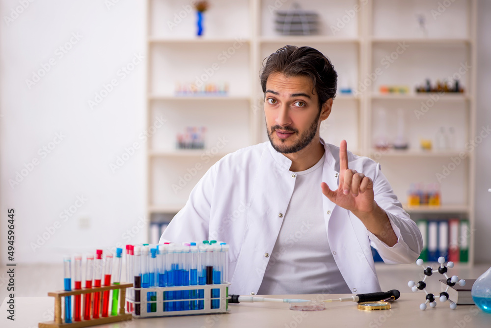 Young male chemist working at the lab Young male chemist working at the lab