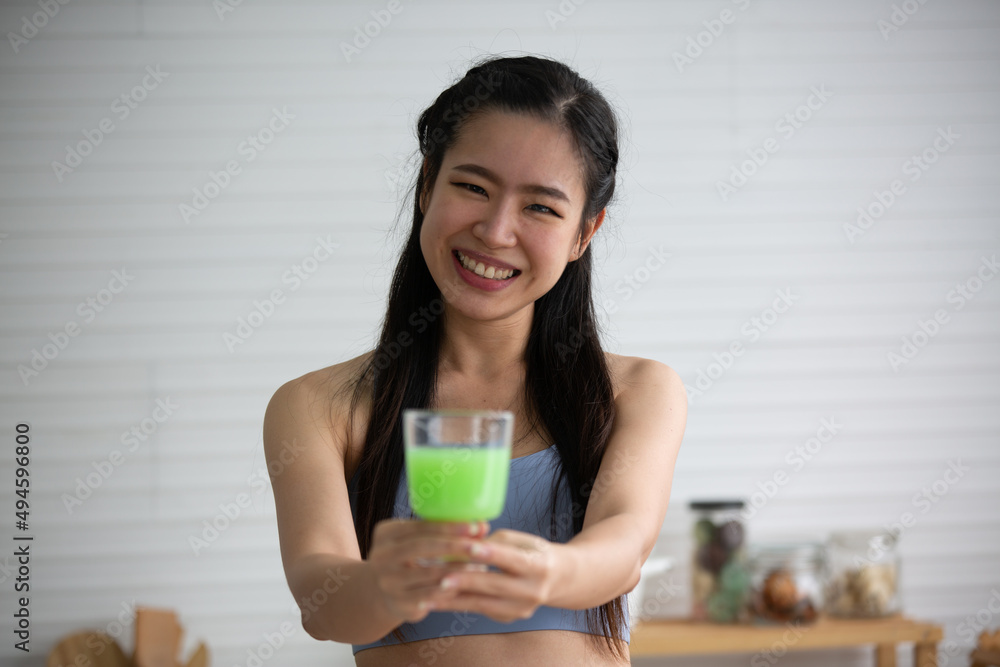young Asian woman cooking vegetable healthy food and eating or drinking in home kitchen young Asian woman cooking vegetable healthy food and eating or drinking in home kitchen