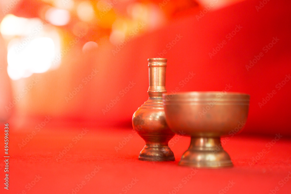 Selective focus of pour water brass on the red carpet at temple in Thailand  and copy space