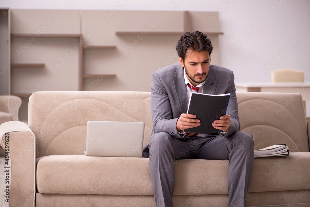 Young male employee working from home during pandemic Young male employee working from home during pandemic